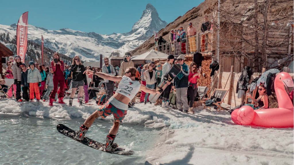 Apres ski, snowboarder at a pond skim competition, in front of the Matterhorn in Zermatt, Switzerland