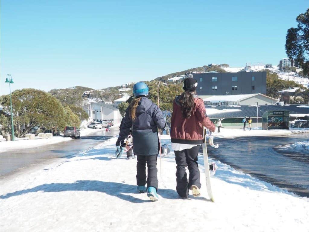 snowboarders walking through the town in Mount Buller Australia