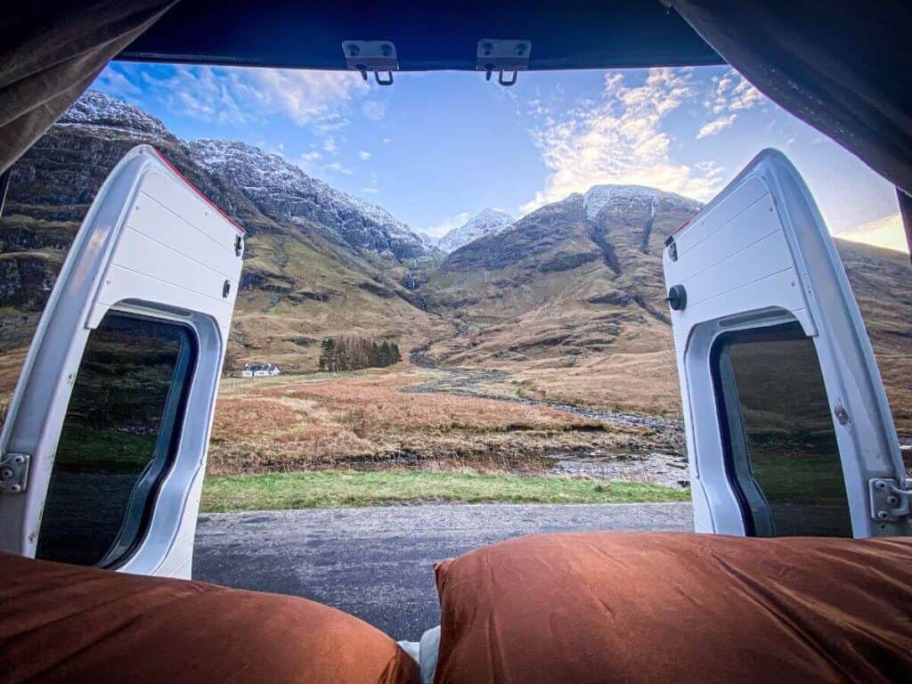 Is skiing in Scotland worth it? We think so, these are the snow capped peaks of Glencoe from the back of a campervan.