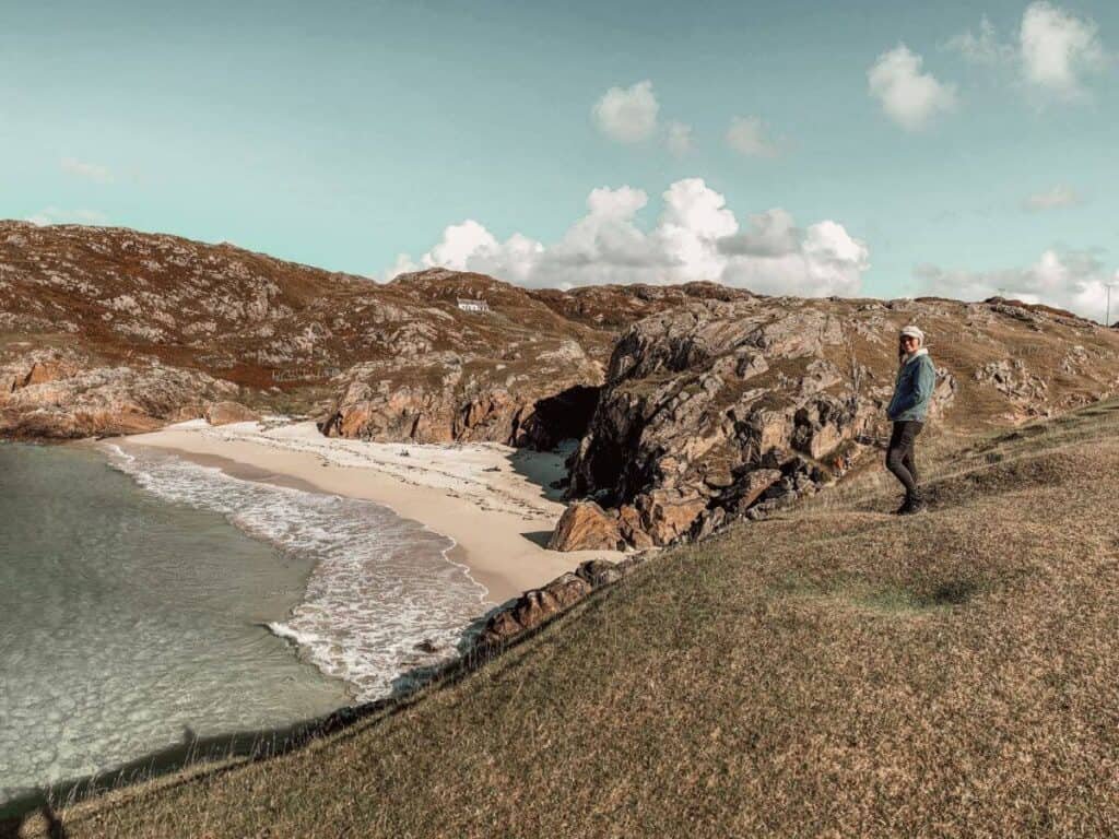 Scotland is worth visiting during the off peak months, so you can experience locations like Achmelvich beach, without the hordes of tourists, like this woman atop the cliffs alone.