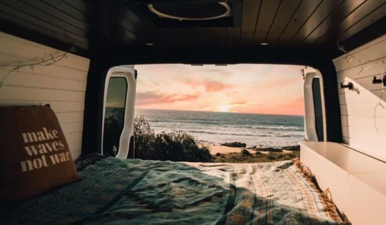 The best thing about vanlife in Australia are the sunset, beach views from your campervan bed.