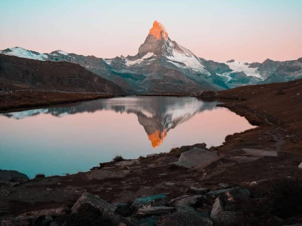 Sunrise over the Matterhorn, giving off aqua and orange hues during October.
