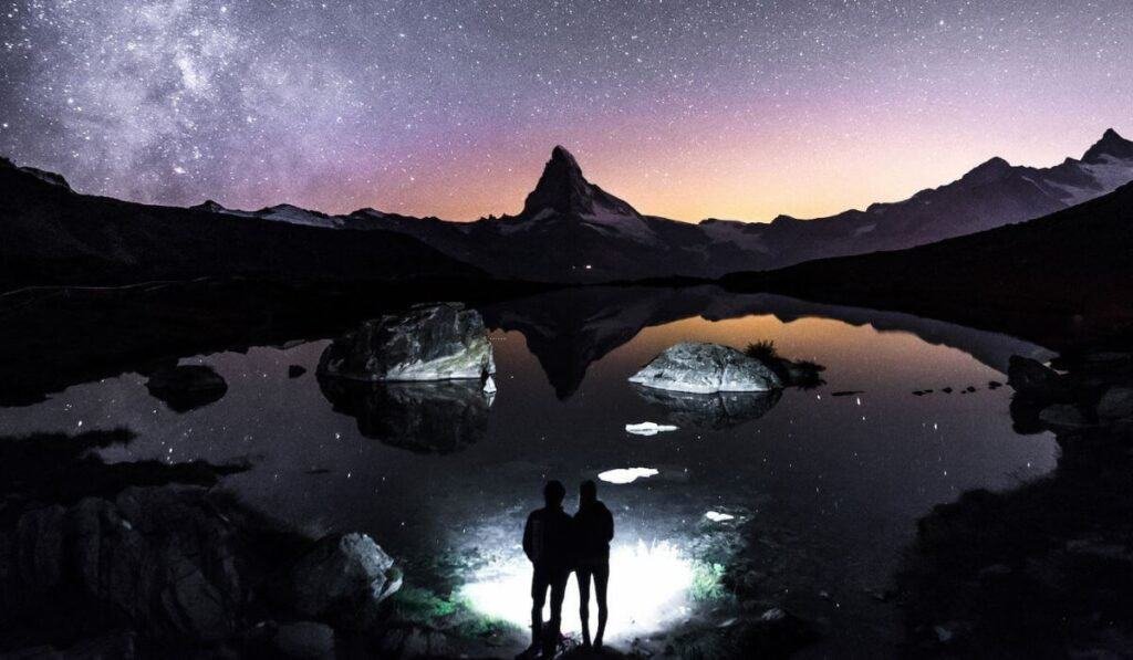 Stargazing at Stellisee lake in Zermatt during October, with the backdrop of the Matterhorn and the Milky Way.
