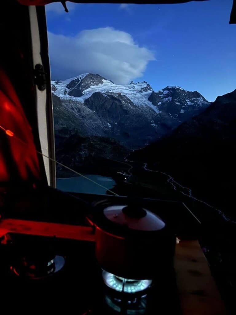 A stove simmering from a campervan parked on the Süstenpass.
