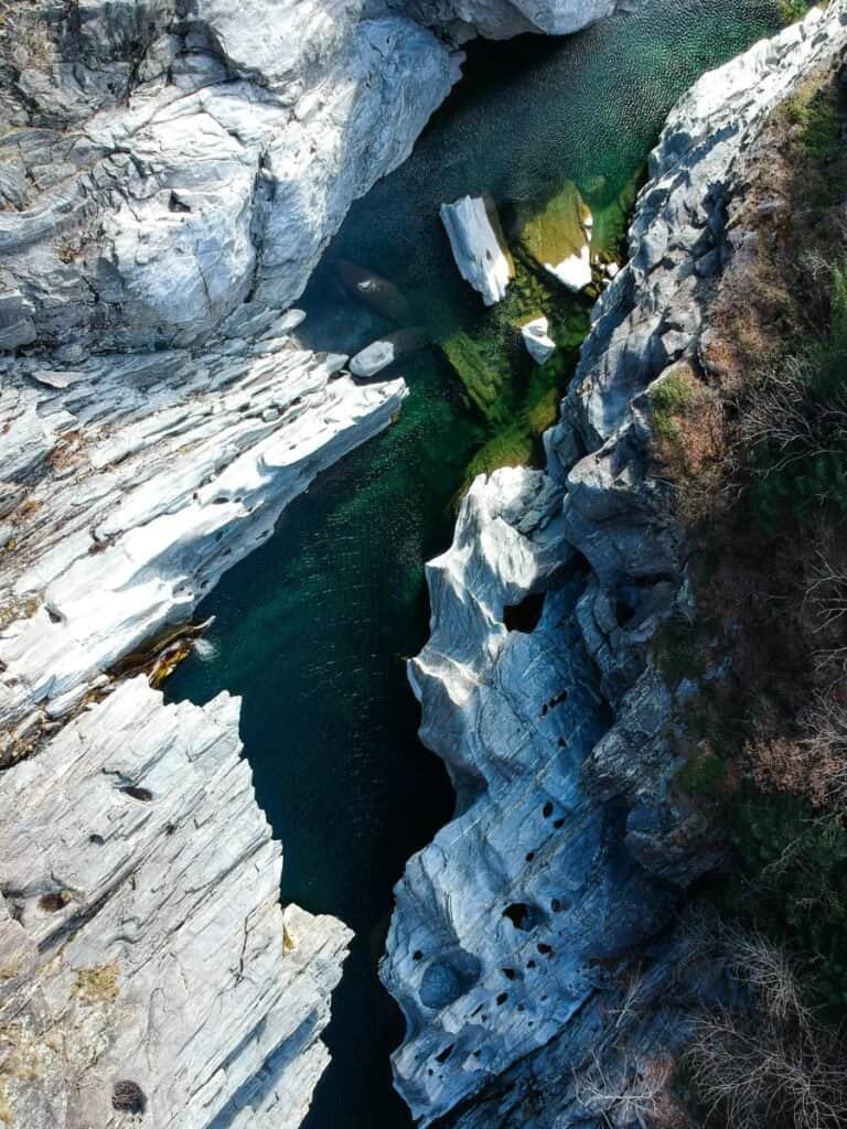 A birdseye view of the glacial river flowing through Ticino, Switzerland.