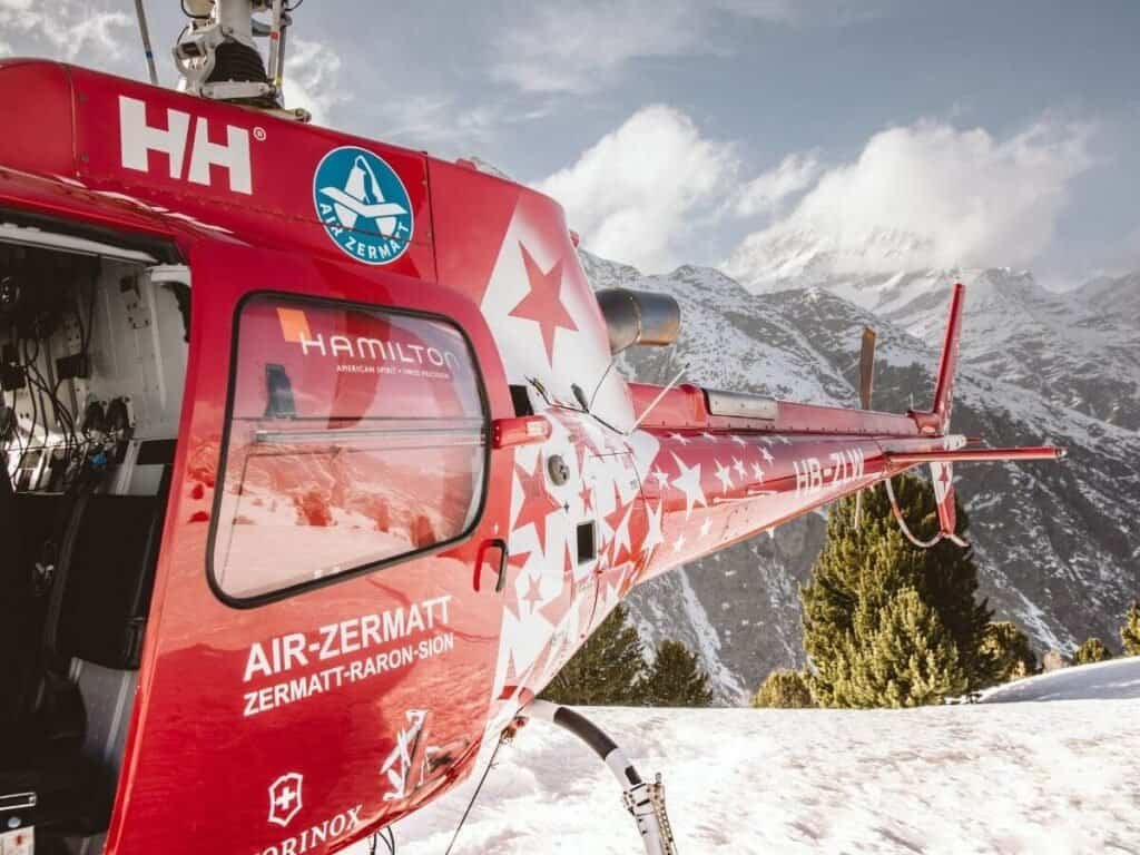 Wondering how to get to Zermatt? You can reach it via helicopter, with Air Zermatt pictured here in the snow.